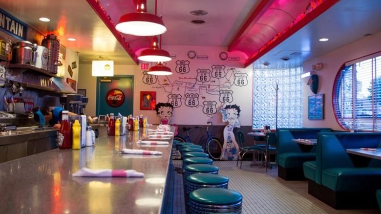 Interior dining area with vinyl booths and counter seating at 66 Diner