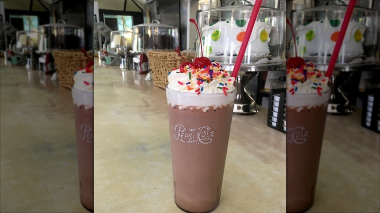Old fashioned milkshake in tall glass with whipped cream and cherry at Historic Village Diner