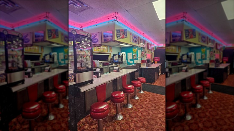 Interior dining area with neon lights and counter seating at Sherri's Diner