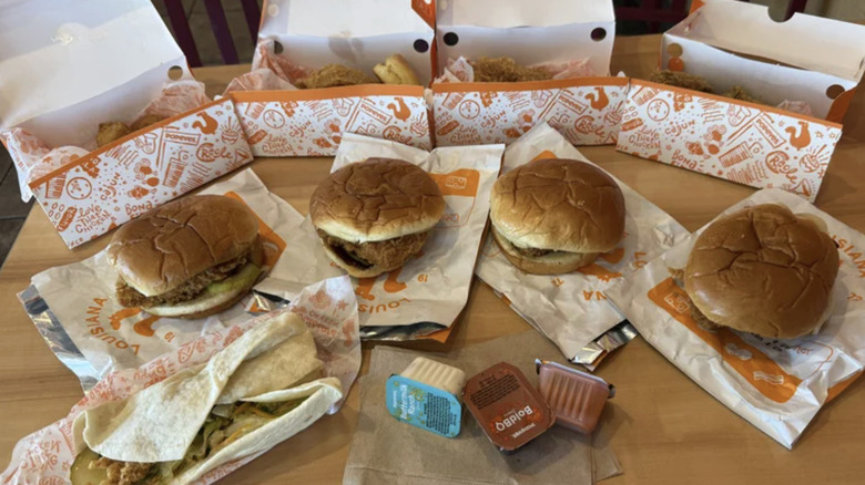 Large array of Popeyes food displayed on table.