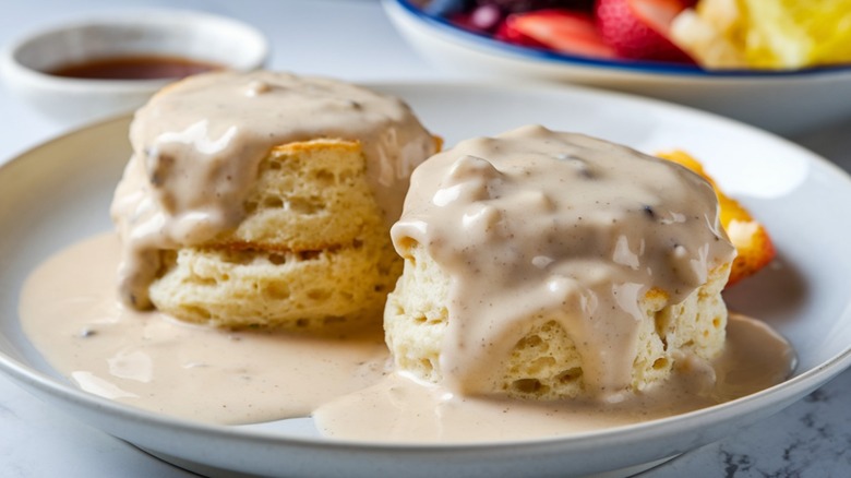 Biscuits and gravy on a white plate