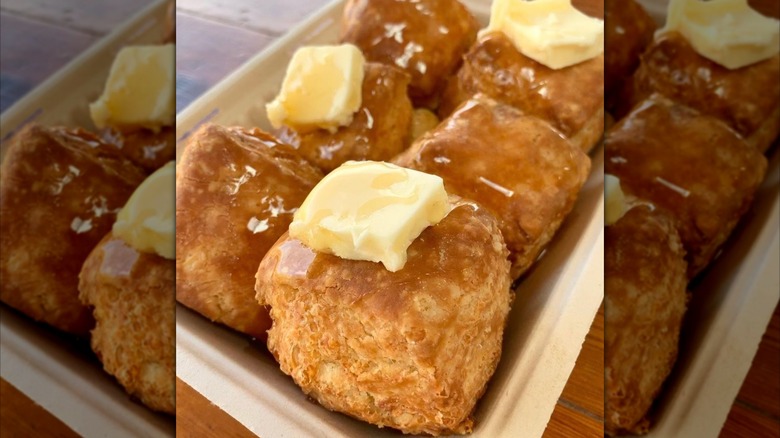 Plateful of buttery biscuits with pats of butter on top at Bird Bird Biscuit