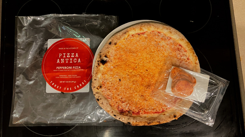 Frozen Pizza Antica on kitchen counter with package and sleeve of pepperoni.