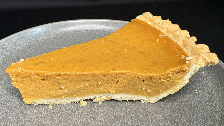 Slice of Costco's pumpkin pie on plate.
