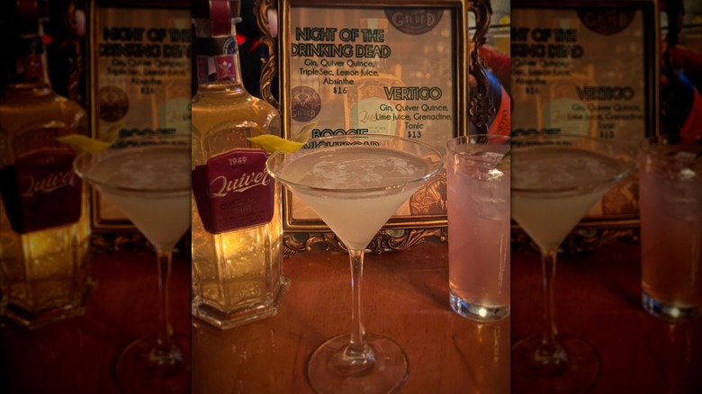 Drinks on a bar in front of a drinks menu at The Gilded Curtain