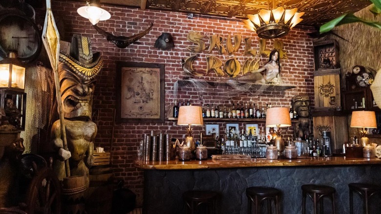 Interior Tiki-bar decor and bar setup at Skull & Crown Trading Co.