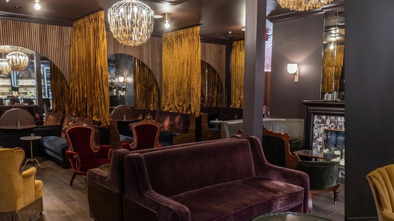 Interior Lounge area with plush sofas and chandeliers at Thick as Thieves