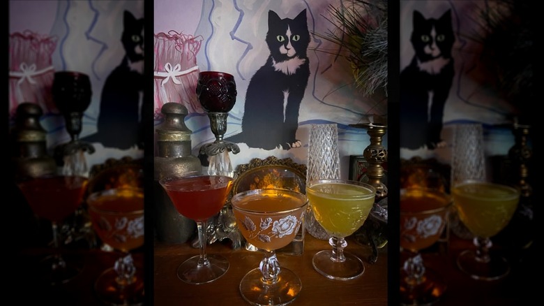 Three colorful cocktail drinks on bar table at The Jewel Box