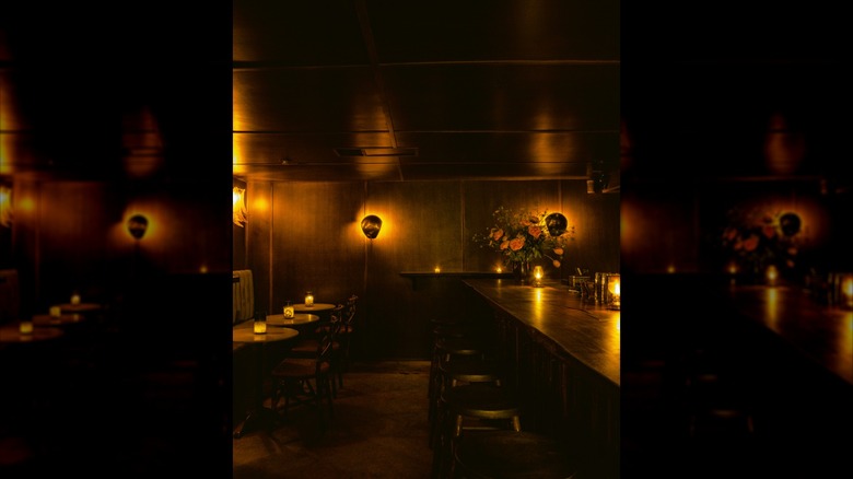 Dark-lit, vibey lounge area and bar setup at The Coral Wig