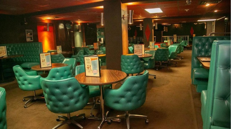 Interior of Starlite Lounge featuring a retro vintage vibe with wooden tables and turquoise seats