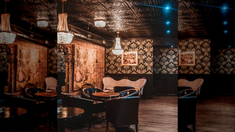 Interior with vintage decor, dim lighting and chandelier at Anastasia's Speakeasy