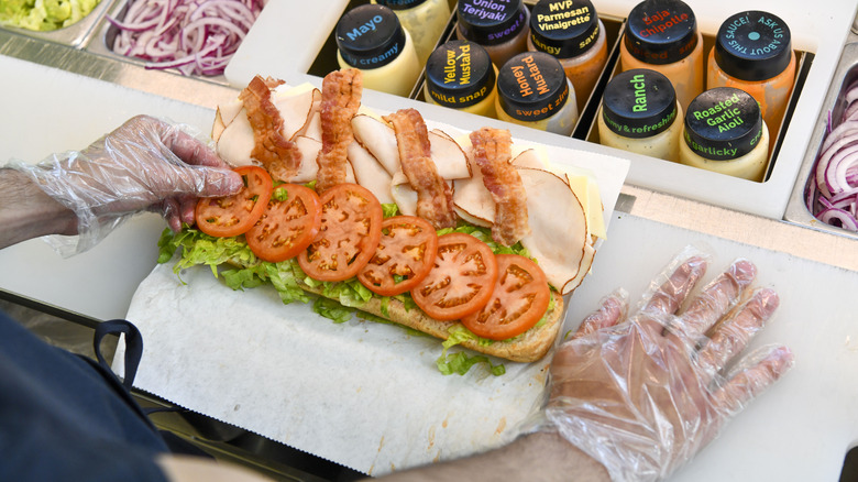 Overhead shot of person making sandwich at Subway