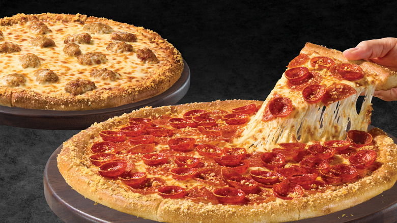 Marco's Pizza pepperoni and sausage pizzas on pizza boards over a dark background.