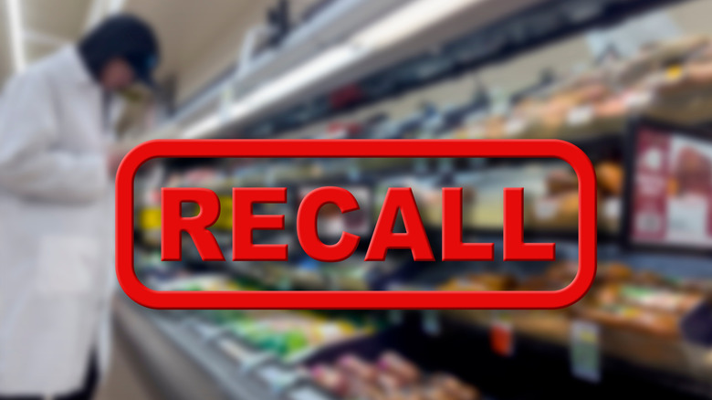 A blurred image of a supermarket worker near a row of shelves under a red image of the word 