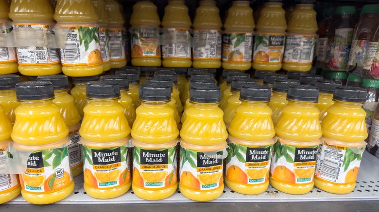 Bottles of Minute Maid orange juice on a grocery store shelf
