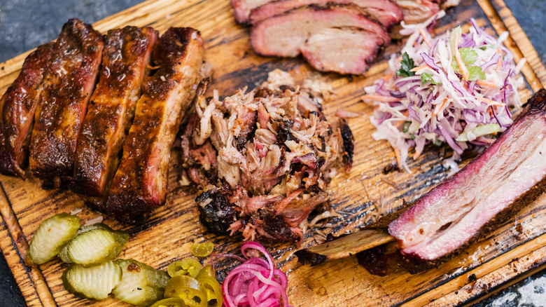 Texas-style BBQ tray with brisket and slaw on wood cutting board