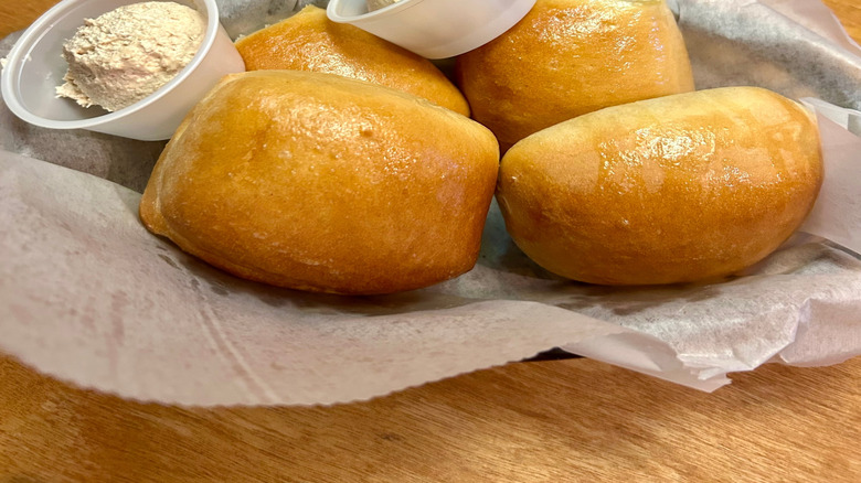Bread rolls in a basket with honey cinnamon butter from Texas Roadhouse
