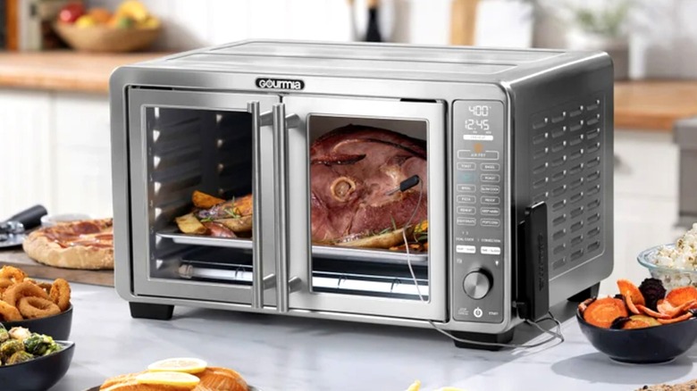 Gourmia countertop oven cooks a ham in a home kitchen