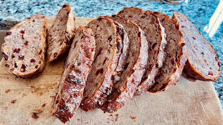 Sliced Costco Kirkland cranberry walnut bread on a board
