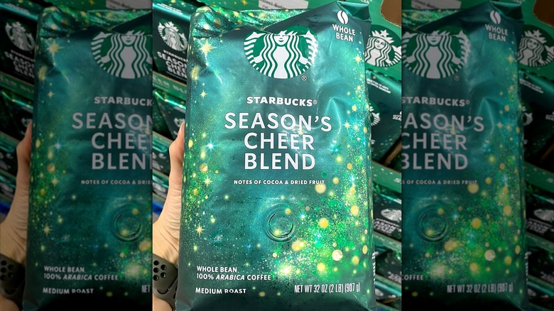 A Costco shopper holds a bag of Starbucks Season's Cheer Blend coffee beans