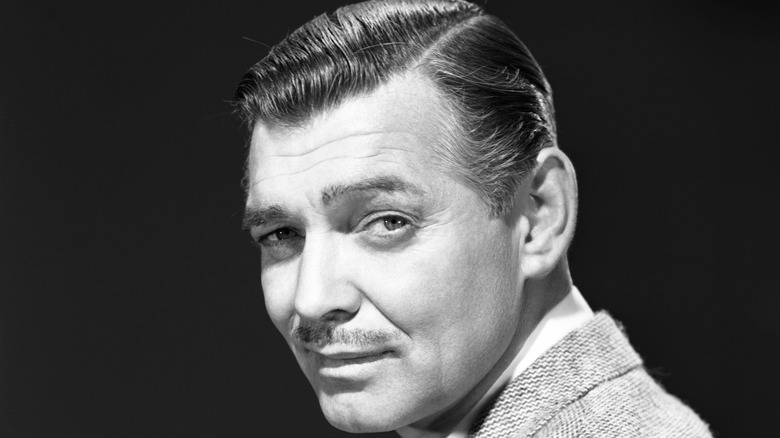 Black and white photo of smirking Clark Gable