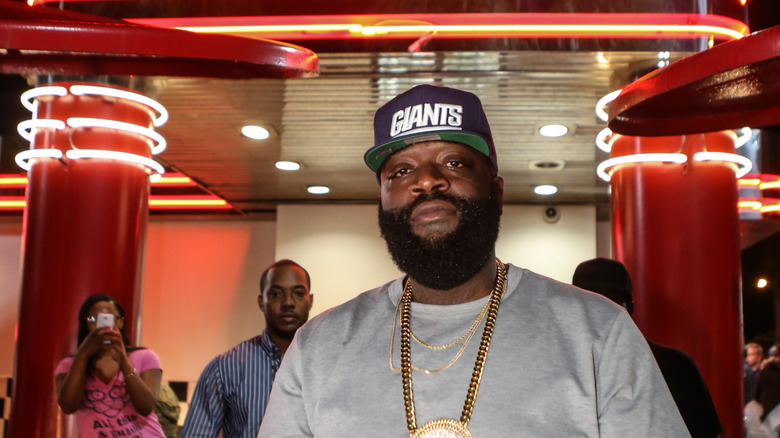 Rapper Rick Ross stands outside a Checkers restaurant