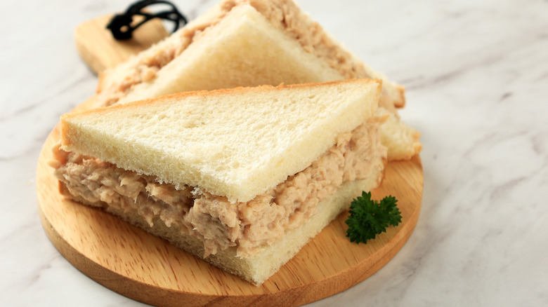 tuna sandwich on a wooden plate