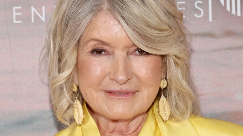 Martha Stewart in a yellow suit and cowrie shell earrings
