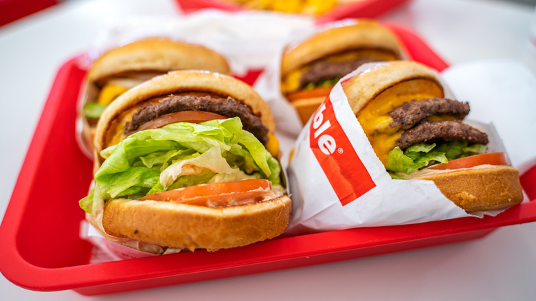Four Double-Double cheeseburgers from In-N--Out on a red tray