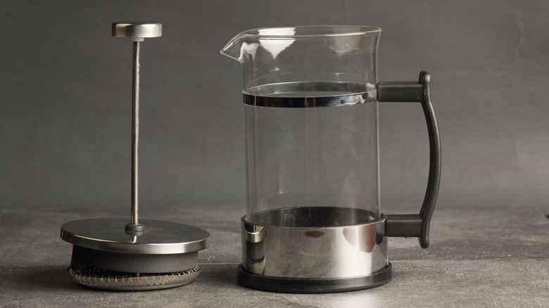 an empty French press with plunger