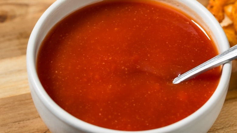 ketchup-based dressing in a white bowl with a spoon