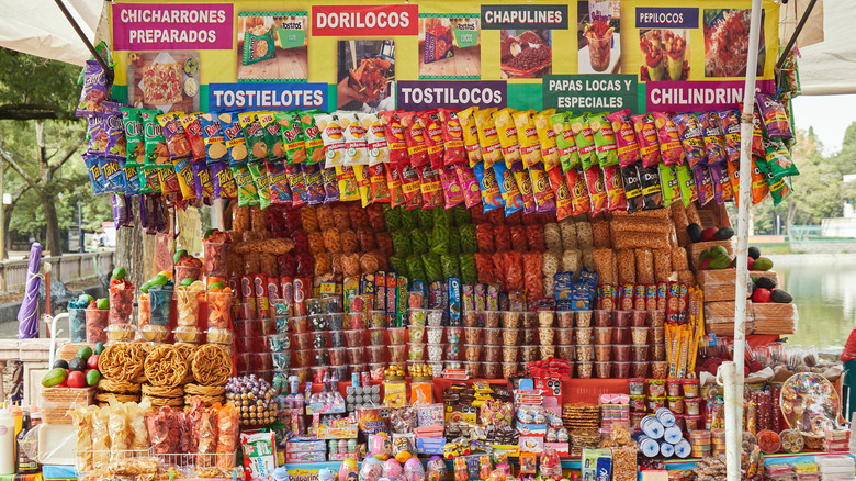 A stall in Mexico sells candy and street food snacks