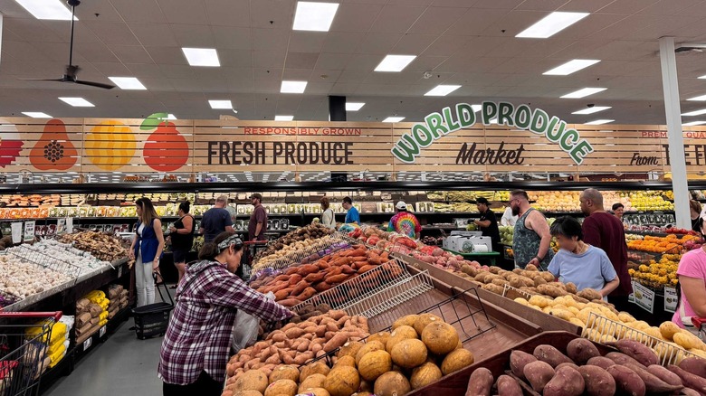 Shoppers in produce section of Saraga market
