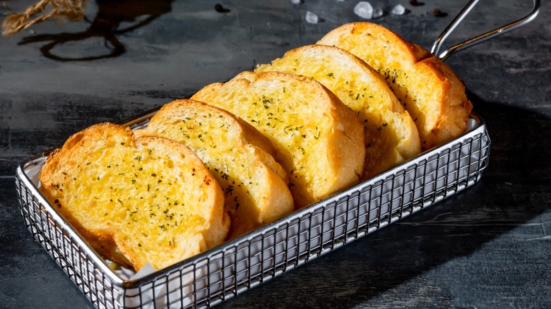 Garlic bread displayed in a little basket