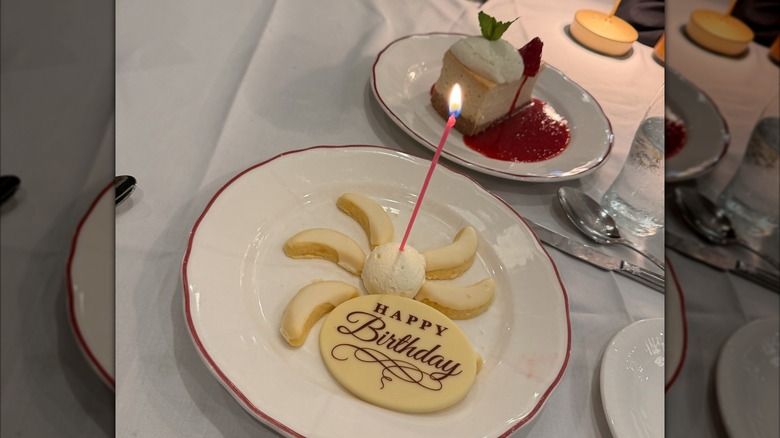 Lemon cookies with lit candle and cheesecake at a Maggiano's restaurant location
