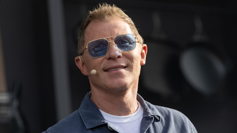 Bobby Flay in blue tinted sunglasses with microphone