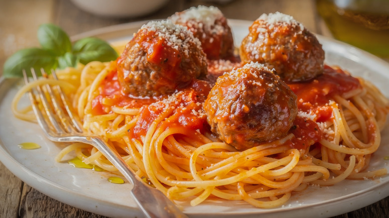 Spaghetti and meatballs with grated parmesan