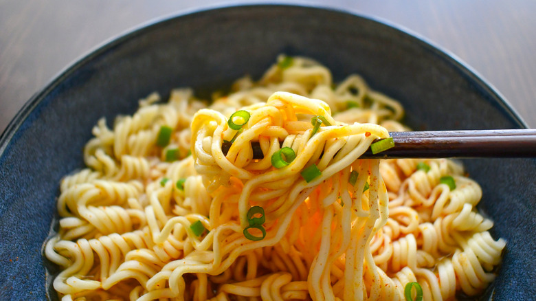 Instant noodles with chopsticks in a bowl