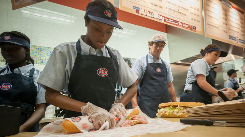 Employee wrapping Jersey Mike's sub sandwich
