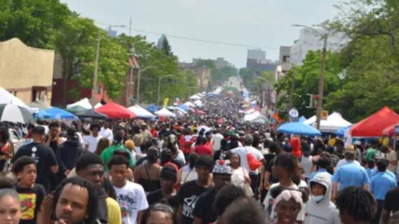 Street view with food and vendor tents set up and a big crowd of people at Milwaukee's Juneteenth Celebration