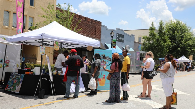 Fountain Inn Juneteenth Festival vendor tent with people lined up in front of it