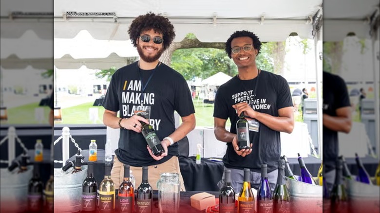 Two vendors holding beverages and smiling at camera at Juneteenth Foodways Festival at the Benjamin Harrison Presidential Site in Indianapolis