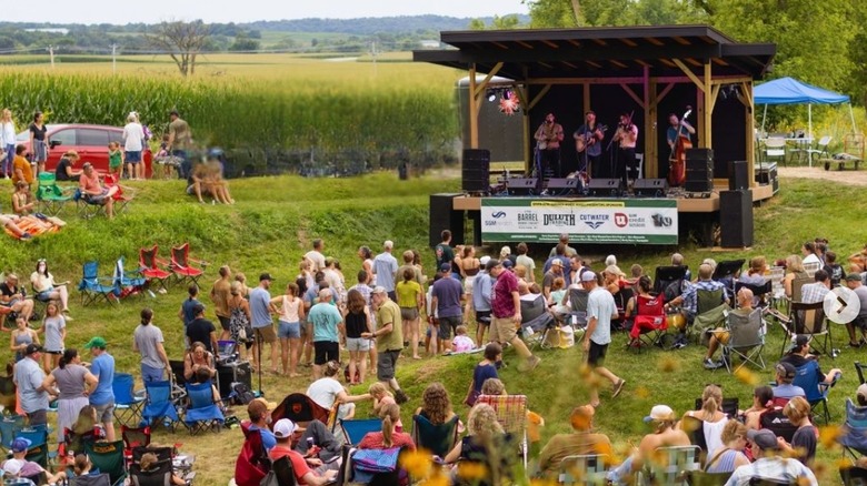 Crowd gathered listening to live music at Seven Springs Farm and Vineyard
