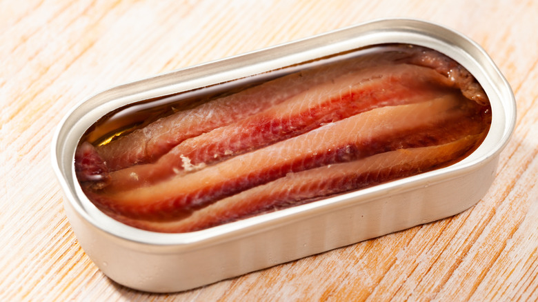 An opened can of anchovy filets