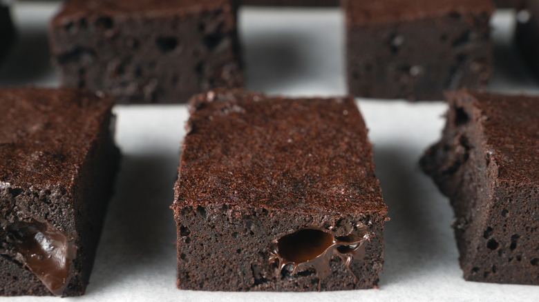 A close-up of brownie squares studded with melted chocolate chips