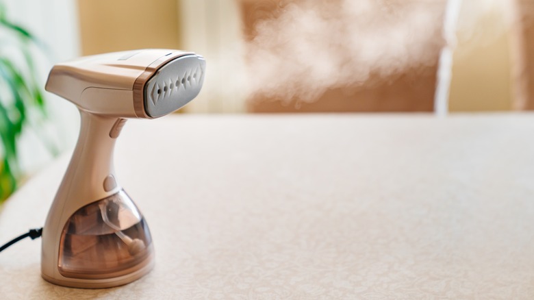 clothing handheld steamer on table