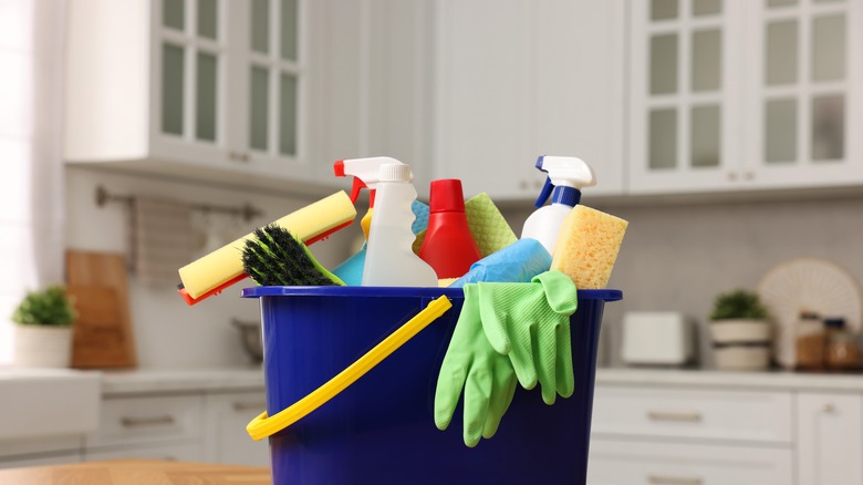 kitchen cleaning products in bucket on kitchen counter