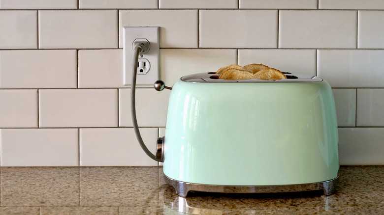 Toaster plugged into wall socket in kitchen