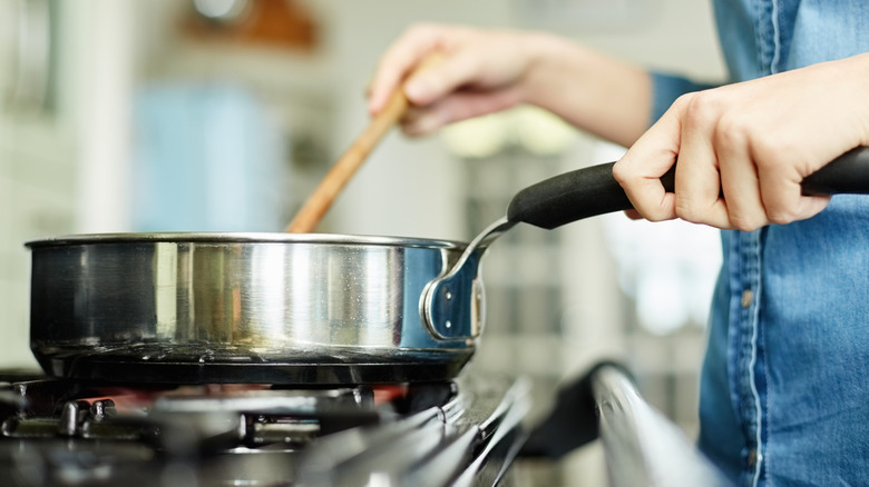 Stirring food in a pan on the stove