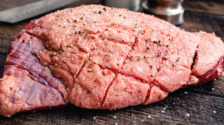 Fat cap on steak that's been scored and seasoned